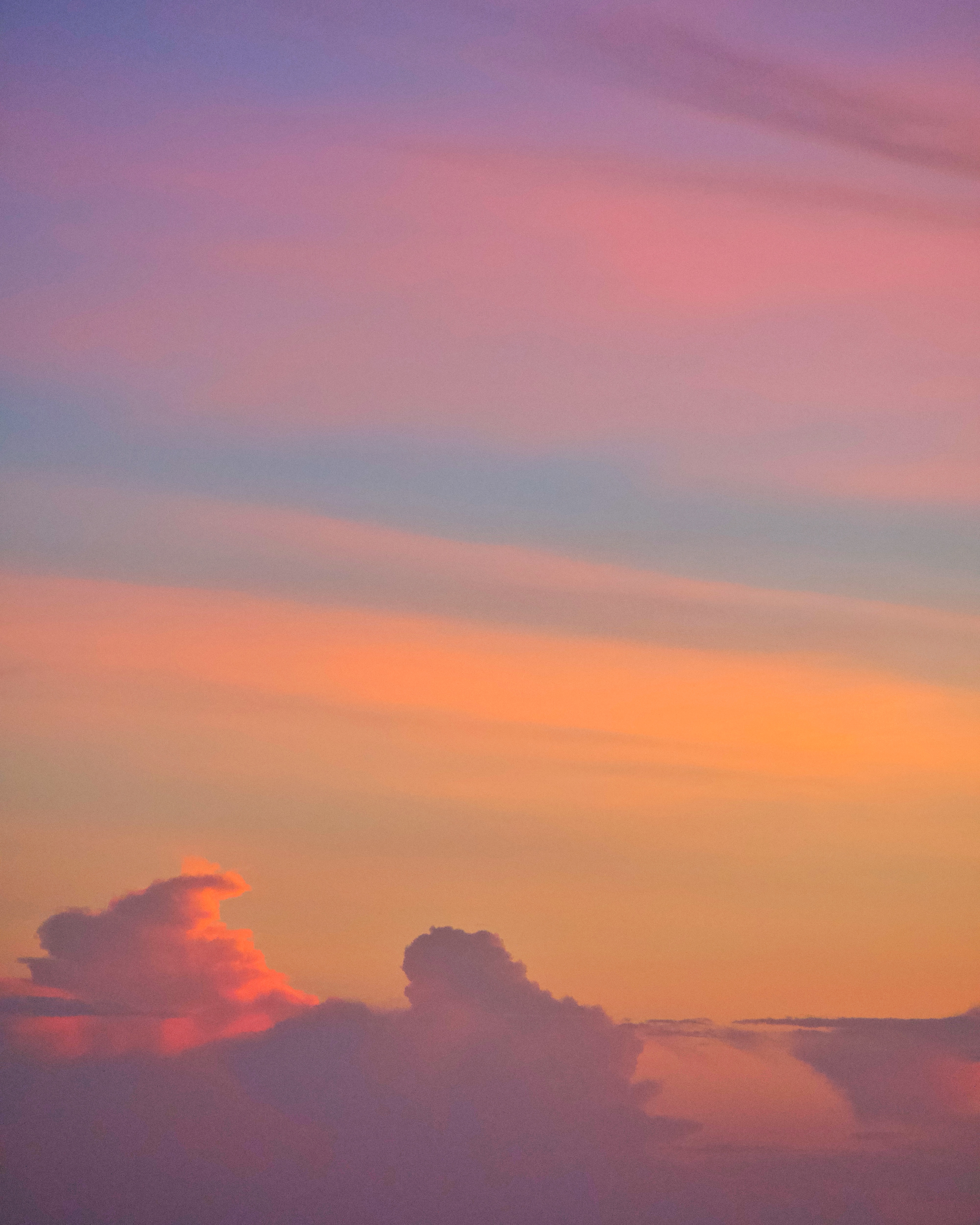A quiet dusk sky, peach fading into lilac